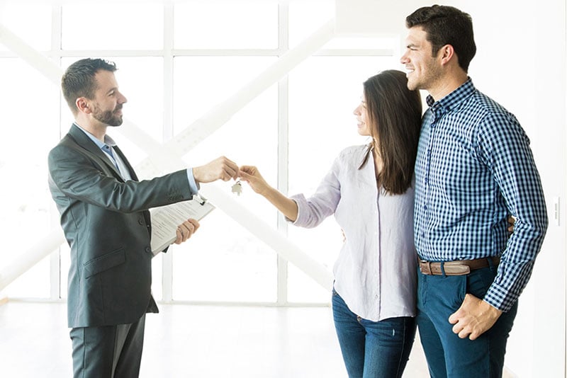 A couple getting keys to their new house