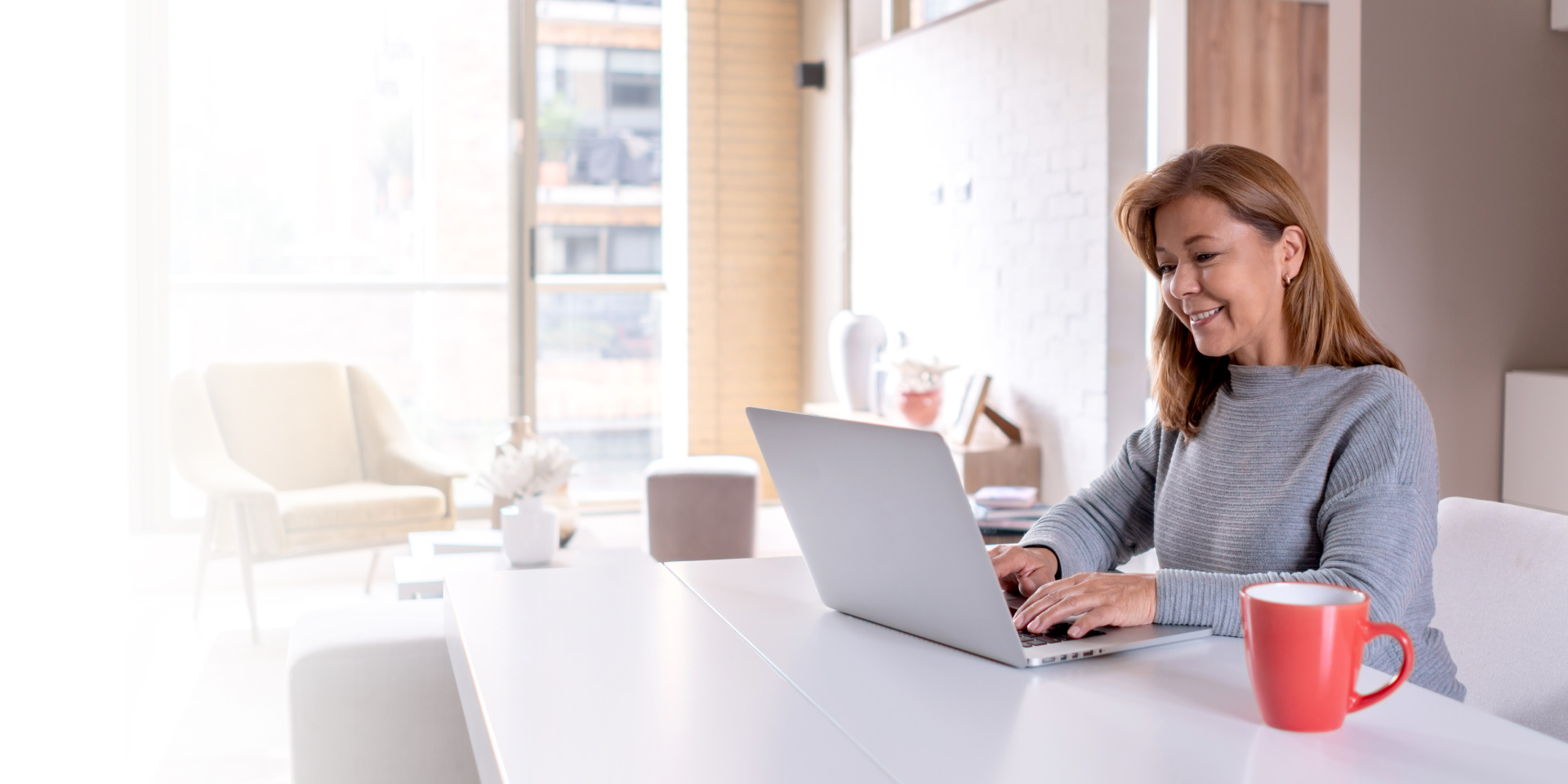 A woman on her laptop accessing Online Banking