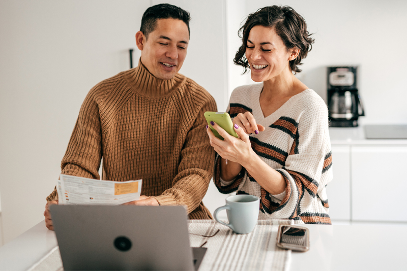 A couple managing their finances on their laptop