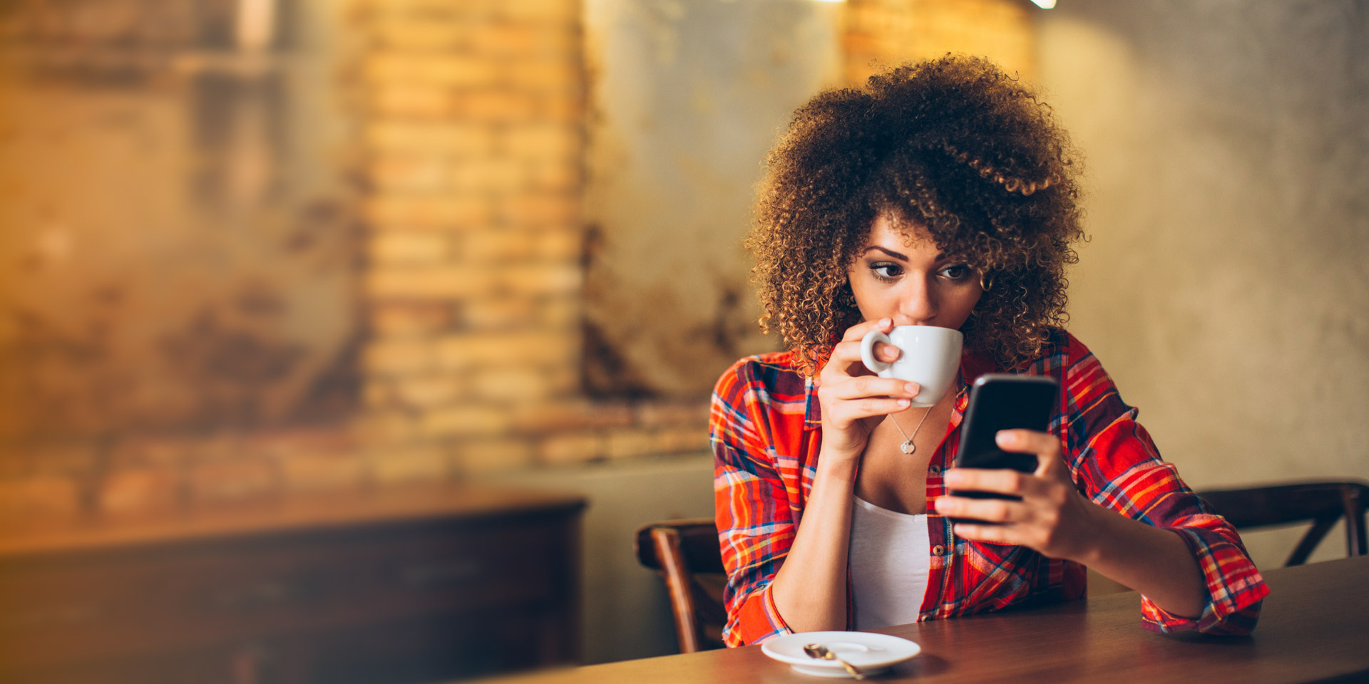 A woman drinking coffee at a table