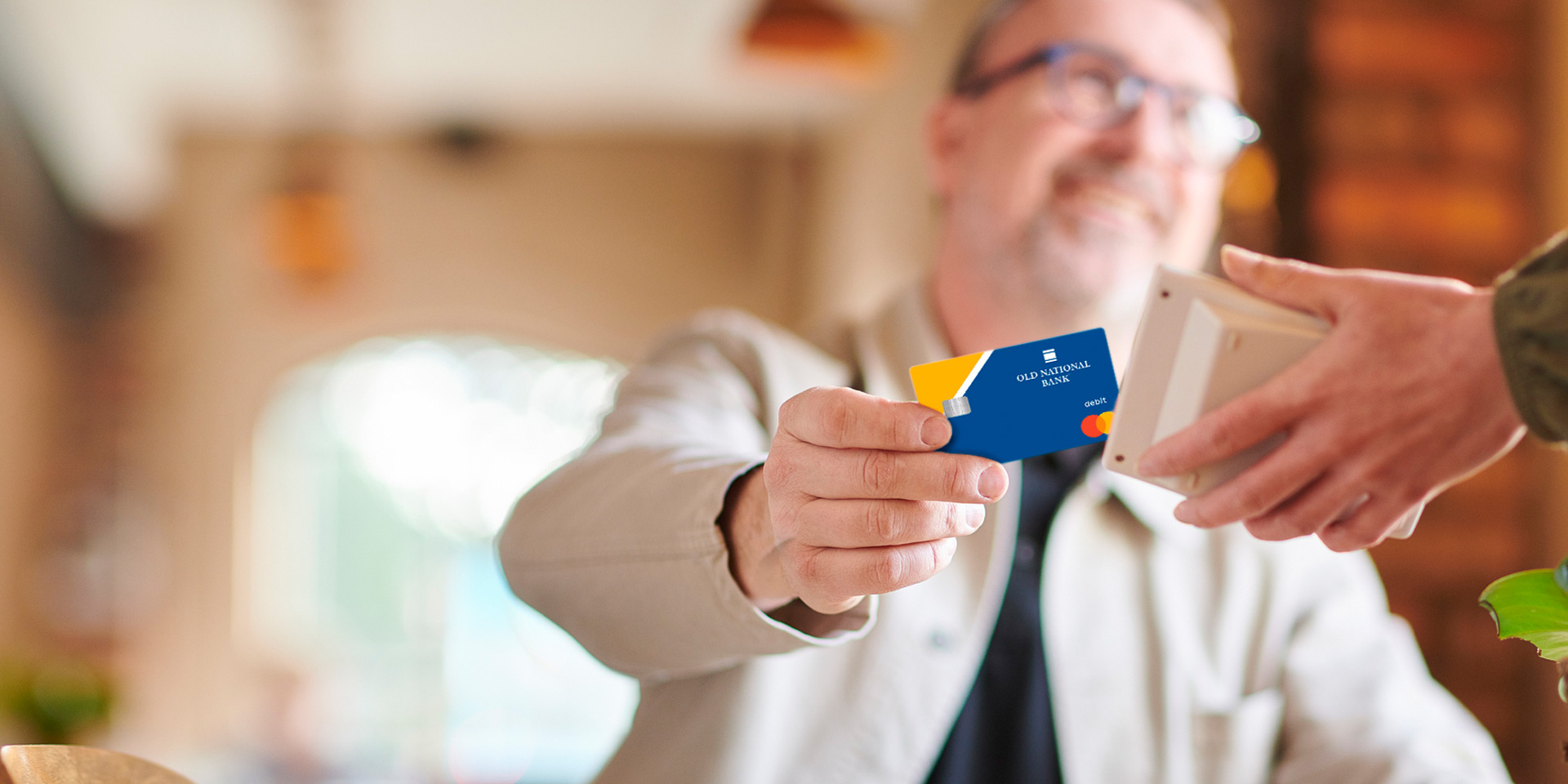 A client using his First Metro Finance debit card at a restaurant