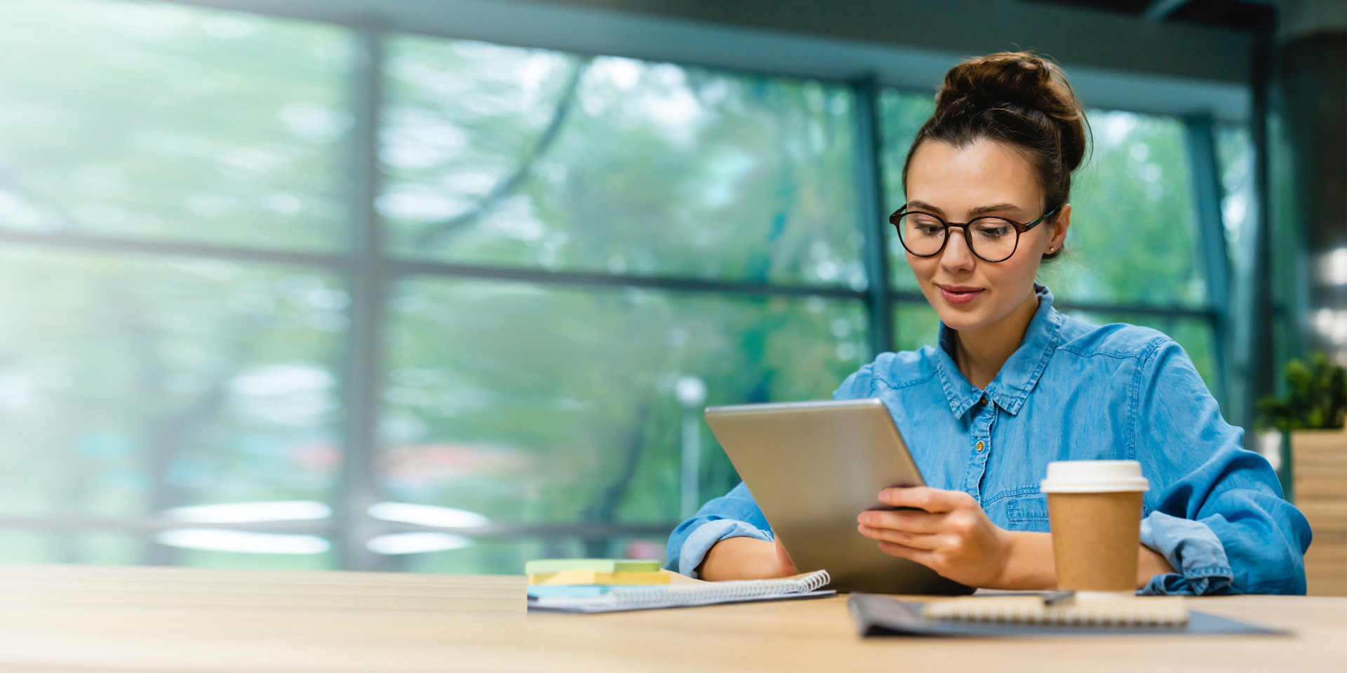 A woman looking at articles on her tablet